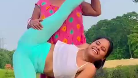 Indian yoga in the field with her mother