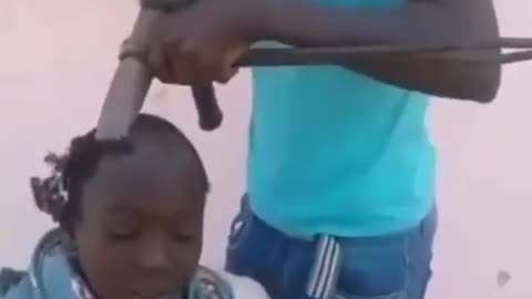 BUHARI BROTHER BARBING HAIR WITH IRON