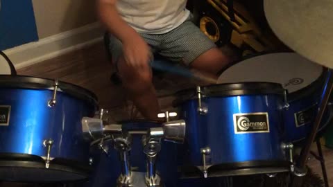 toddler rocks out on drum solo