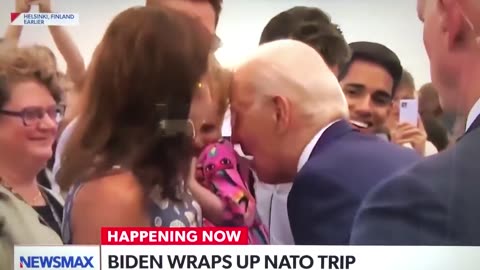 Biden nibbles on frightened young girl during trip to Finland
