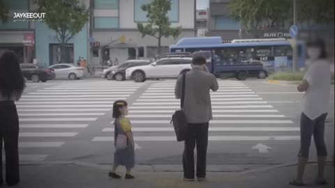 A chid asking adult to hold hands across the street