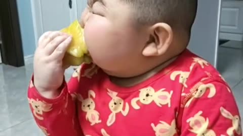 chinese boy eating fruit