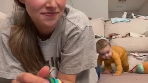 Baby Crawls Over to Mom for Toy and Phone