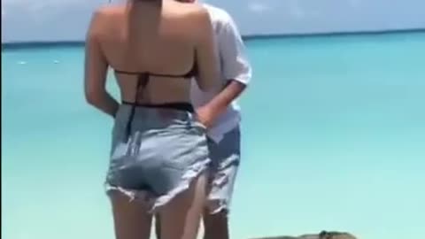 dude slaps chicks ass then face plants on slippery rock and slides into water.