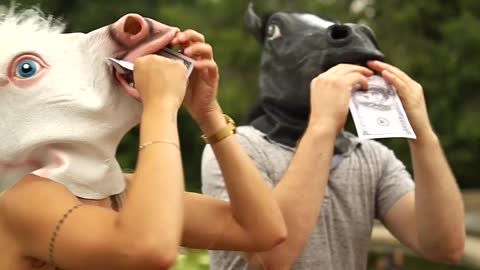 People With Pony Mask Eating Phony Paper Money