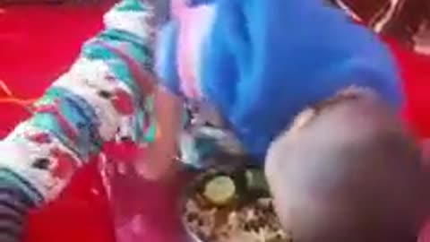 Baby eating meal in funny style