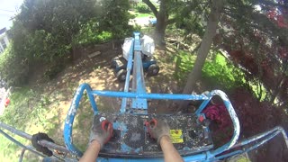 Genie 65 foot man-lift to trim back a tree