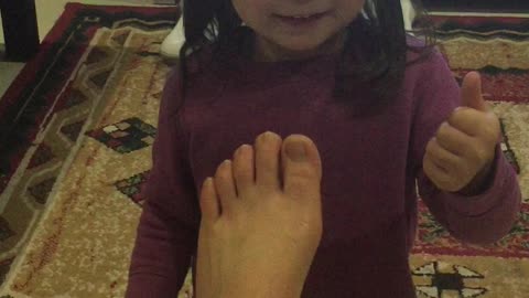 3 year-old girl having fun massage Mummy's feet