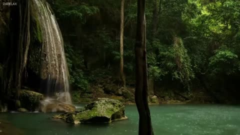 Small waterfall with rocks and trees around it