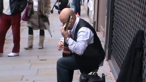 classical guitar player at king street manchester uk