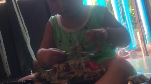 little boy sitting and playing with toys
