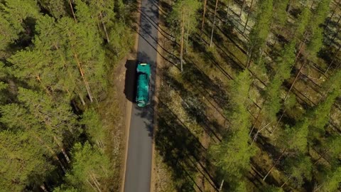 aerial view of the forest in finland car moving on the road top view beautiful nature of finland