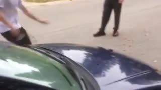 Guy sliding on front of car