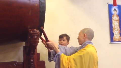 Boy drumming at Buddhist Temple