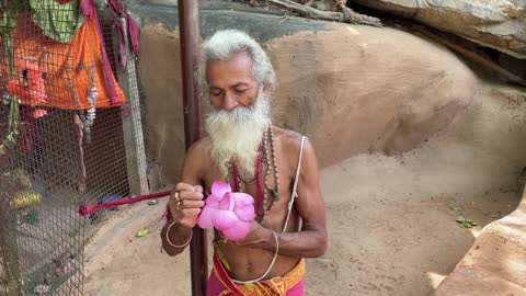 Dayalu Baba Shows Us One of the Lotus Flowers from the Ashram Pond