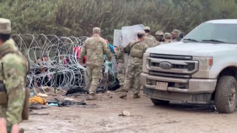 Texas National Guard managing migrants using riot shields in Eagle Pass, TX