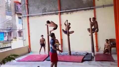 Group of Gymnasts Practice Indian Sport of Mallakhamba