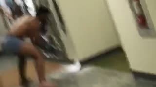 Guy in blue underwear hitting wall with boxing gloves