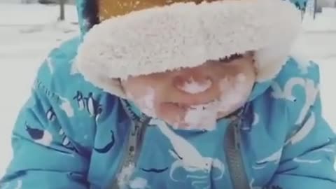Cute Baby Eat the ice in snow fall