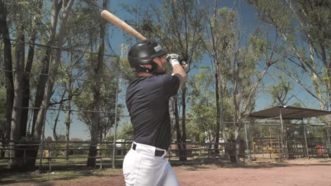 A man stands at home plate holding a bat.