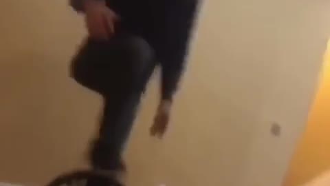 Man gets hyped up to balance standing on a chair, man falls and slams face into table