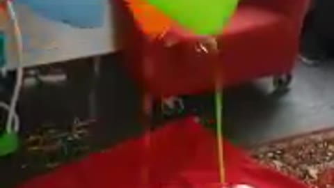 New born baby playing with balloons