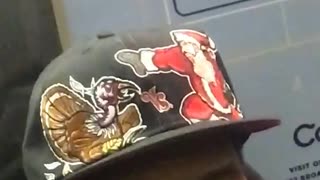 Man with turkey and santa on black hat