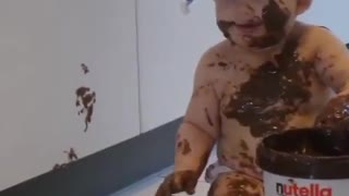 A baby is left alone with a giant tub of Nutella. You can imagine what happens next.