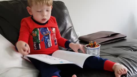 Wee man coloring on a Sunday