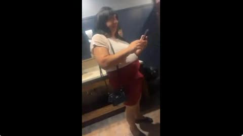 Man with an erect penis waits in line in a women’s restroom!