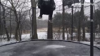 Kid back flips in snowy black trampoline lands on neck