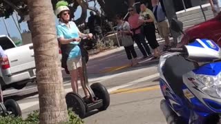 Weekend u old people ride segways down sidewalk