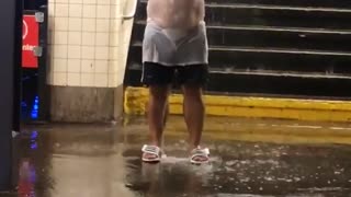 Man with hat and white shirt under water falling