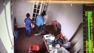 Guy leans back on his office chair and falls back against door
