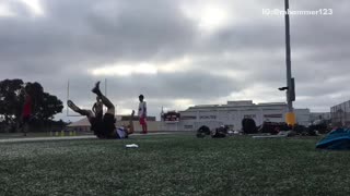 Guy tries to catch football and falls down on back
