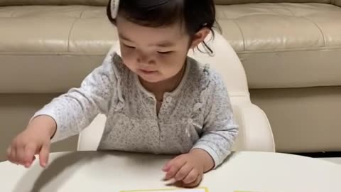 Baby having fun studying animals.