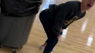 Guy booty bumps and twerks a pencil into trash can