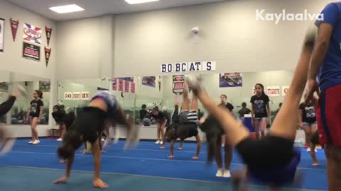 Gymnastics girls do back flip, girl in front lands on her head