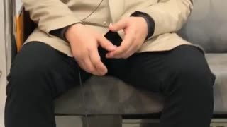Man sleeping subway earphones phone on floor