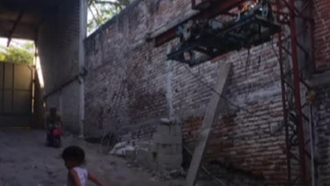 Man rides a mini bike off a make shift wooden ramp