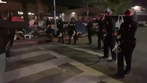 Computer thrown on a riot cops head during a protest in Hollywood(0)