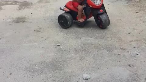 child riding a motorcycle