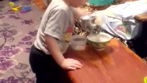 the boy turns pasta through a meat grinder