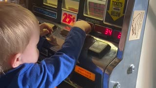 Grandson playing with grandpa’s piggy bank.