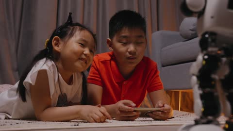 Children Playing with a Toy Robot