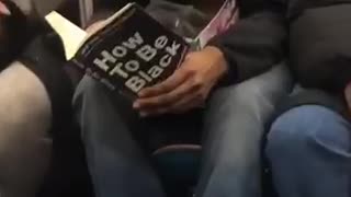 Man reading book how to be black