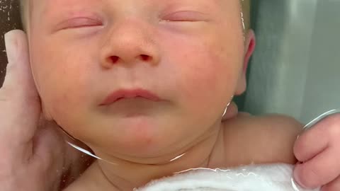 Newborn baby meditates peacefully while floating