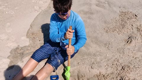 Spencer digging at the beach VID_20210904_141908