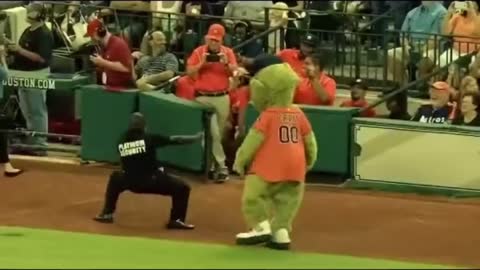 A funny mascot dances in front of a security guard who starts the dance too 🤣😂