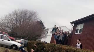 Guy jumps off roof of beige house